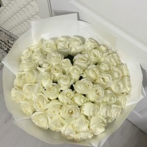 Luxurious bouquet of white roses elegantly wrapped in white paper, perfect for weddings, anniversaries, and special occasions.