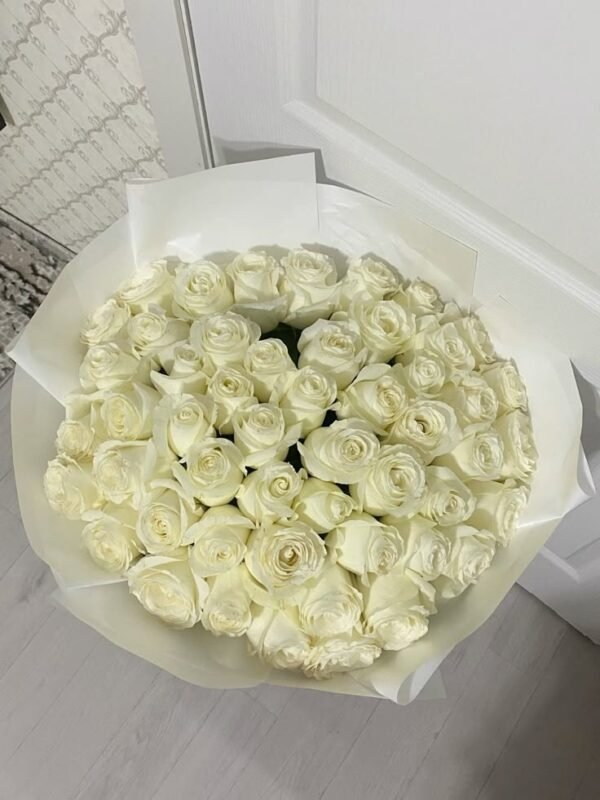 Luxurious bouquet of white roses elegantly wrapped in white paper, perfect for weddings, anniversaries, and special occasions.