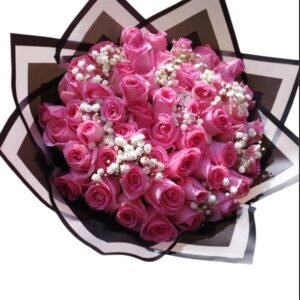 Luxurious bouquet of pink roses with delicate baby's breath, elegantly wrapped in black and white paper, perfect for romantic gestures and special celebrations.