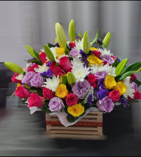 A stunning floral arrangement featuring a mix of red, yellow, and lavender roses, complemented by white chrysanthemums, purple accents, and fresh green lily buds. Arranged in a rustic wooden crate, this bouquet combines elegance and vibrancy, making it a perfect choice for any special occasion.