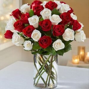 A stunning bouquet of red and white roses elegantly arranged in a glass vase, creating a classic and sophisticated floral display perfect for any special occasion.