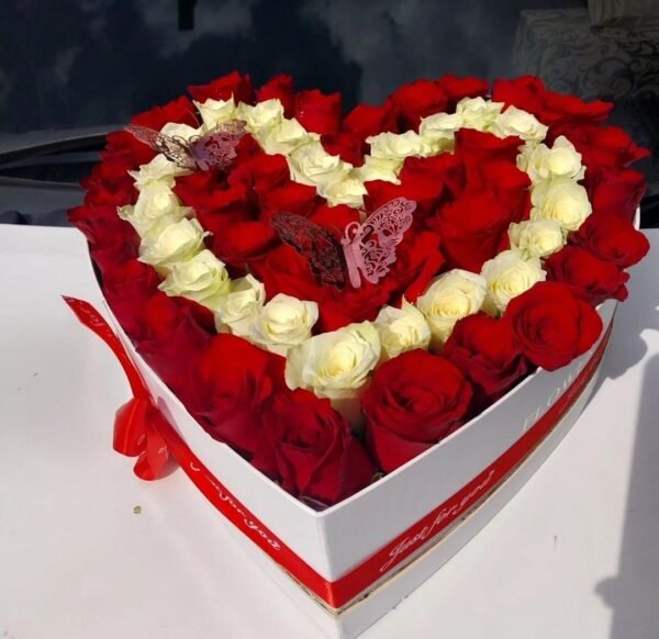 A romantic heart-shaped arrangement of red and white roses, beautifully presented in a decorative box with a ribbon. Perfect for expressing love, passion, and devotion on special occasions.