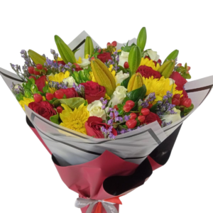 A vibrant bouquet featuring red roses, yellow chrysanthemums, white flowers, unopened lily buds, and small purple blossoms, wrapped in elegant black and red paper with a white ribbon.