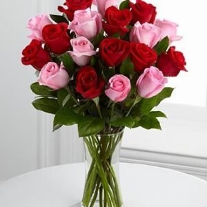 Beautiful bouquet of red and pink roses arranged in a clear glass vase, perfect for romantic gifts and special occasions.