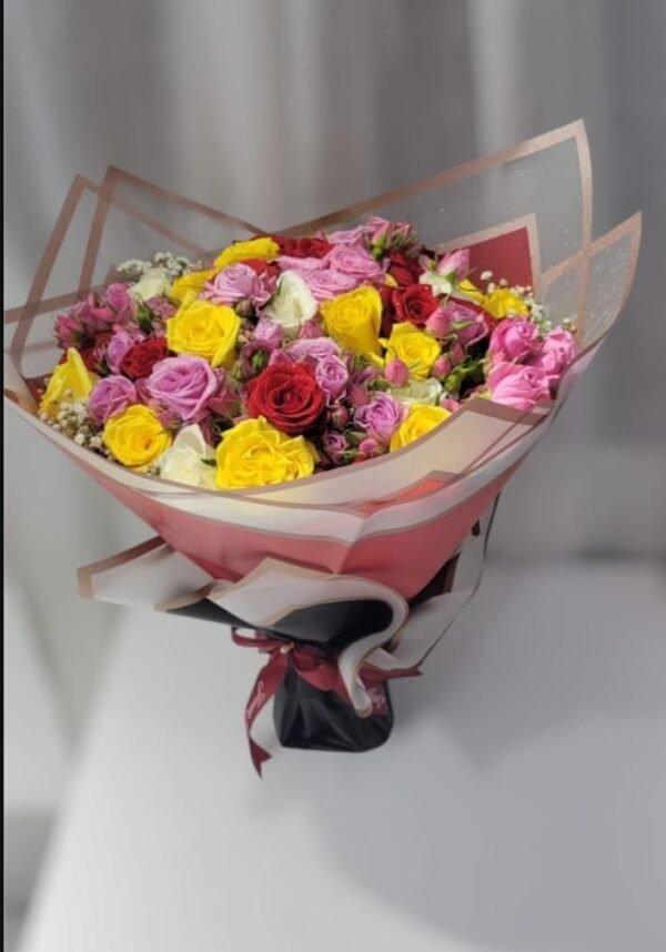 A beautifully arranged bouquet featuring a mix of red, yellow, pink, and lavender roses, wrapped elegantly in layered paper with a stylish ribbon. This vibrant and romantic floral arrangement makes for a perfect gift for special occasions, expressing love, joy, and appreciation.