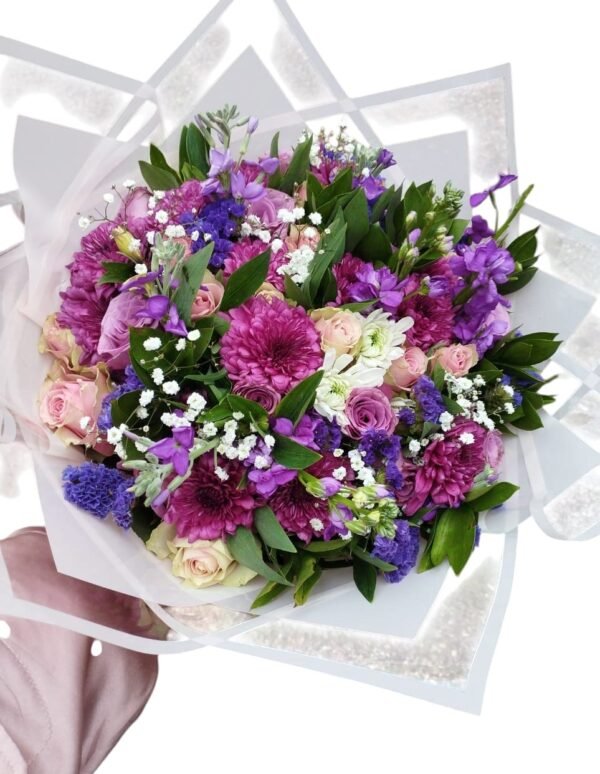 A beautiful bouquet featuring a mix of purple, pink, and white flowers, accented with lush greenery and delicate baby's breath, wrapped elegantly in white paper. A perfect choice for a romantic or celebratory occasion!