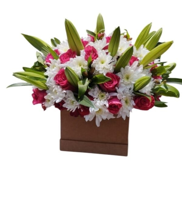 This is a beautiful floral arrangement in a box, featuring pink roses, white chrysanthemums, and fresh lilies with their buds still closed. The mix of colors and textures creates a stunning and elegant display—perfect for gifting or decorating a special space!